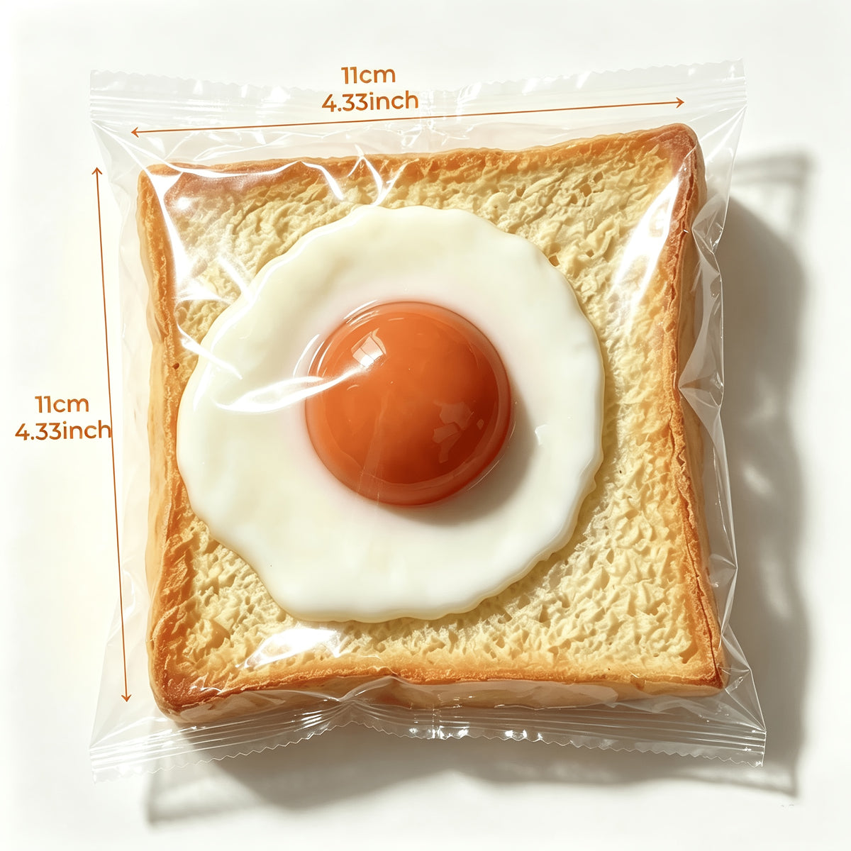 Stressleksak som kläms ihop, rostat bröd med stekt ägg