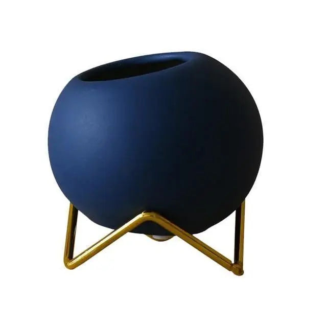Macetas decorativas redondas con soportes metálicos geométricos
