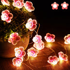 Dekorativ LED-lyskæde med lyserøde blomster