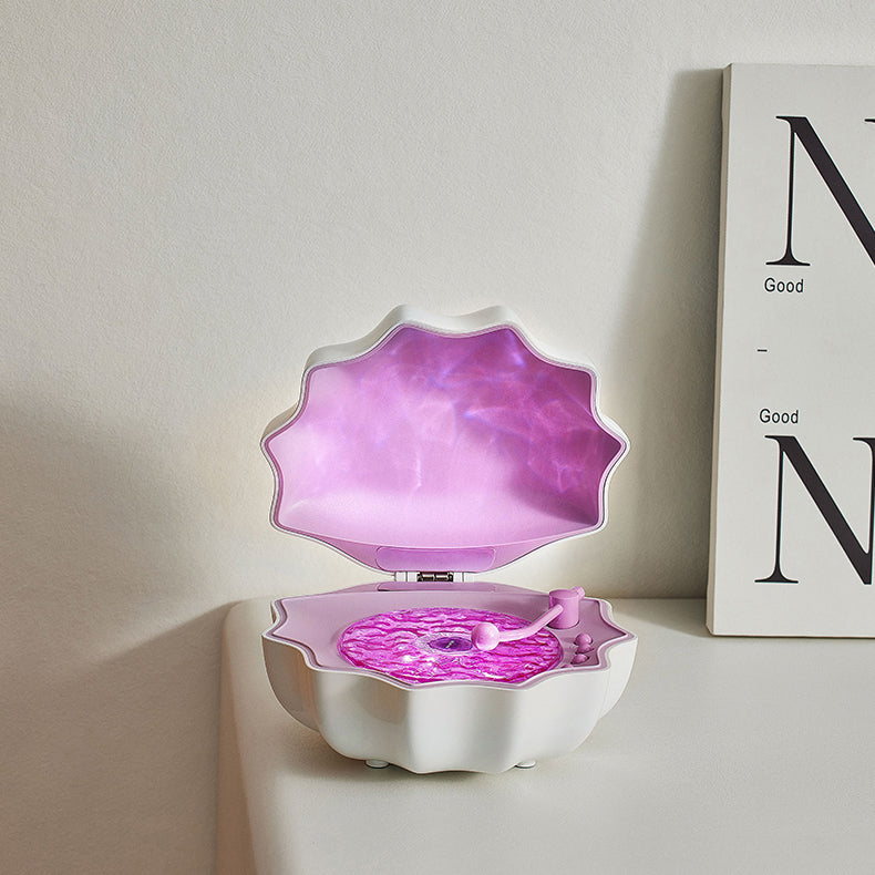 LED-natlampe formet som en muslingeskal med Bluetooth-højttaler