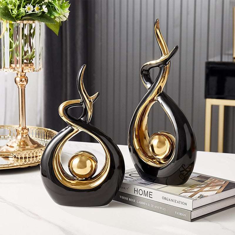 Figuras decorativas esculturales abstractas con curvas entrelazadas y detalles esféricos