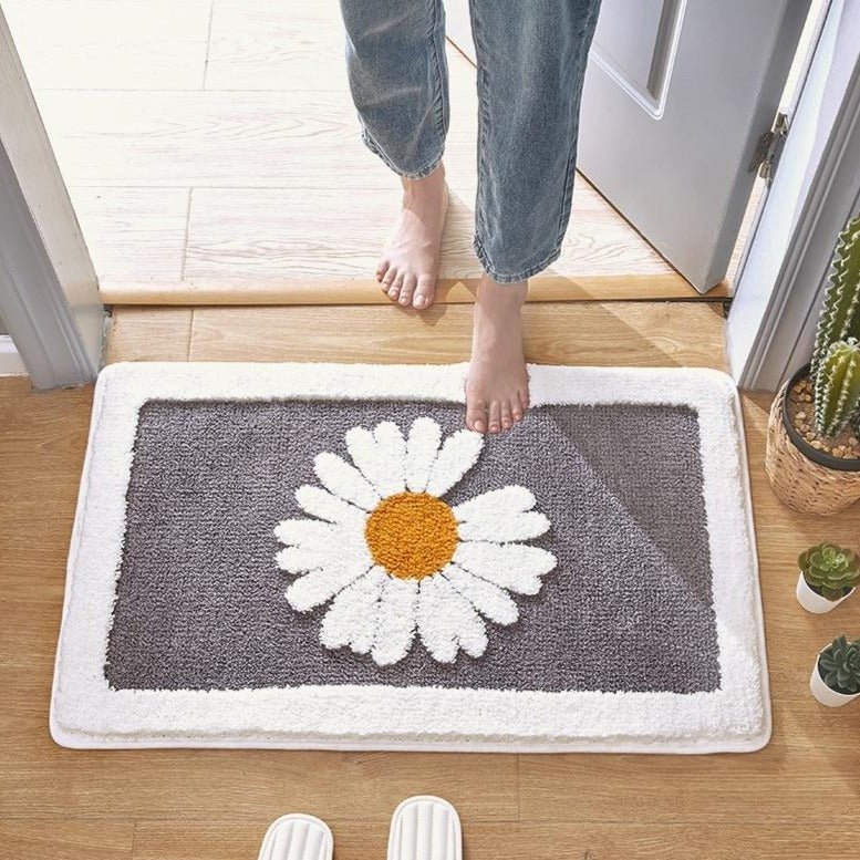 Alfombrilla de baño de felpa con motivo floral y borde en contraste