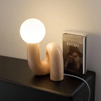 Skulptural böjd bordslampa i harts med glaskupa