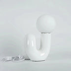 Skulptural böjd bordslampa i harts med glaskupa