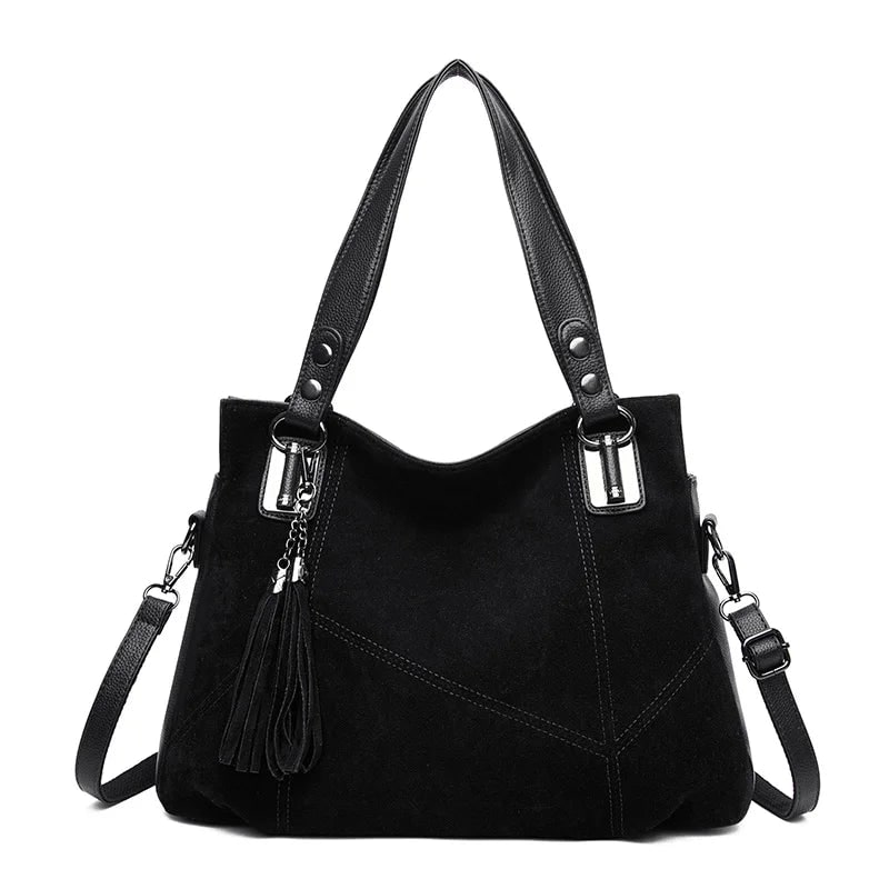 Axelhandväska med tofsdetalj